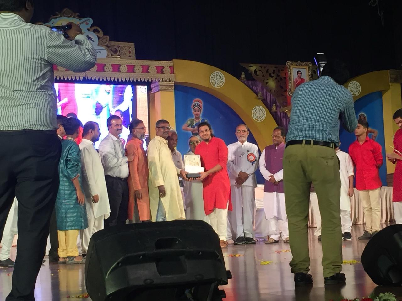 Raghavendra receiving award on stage